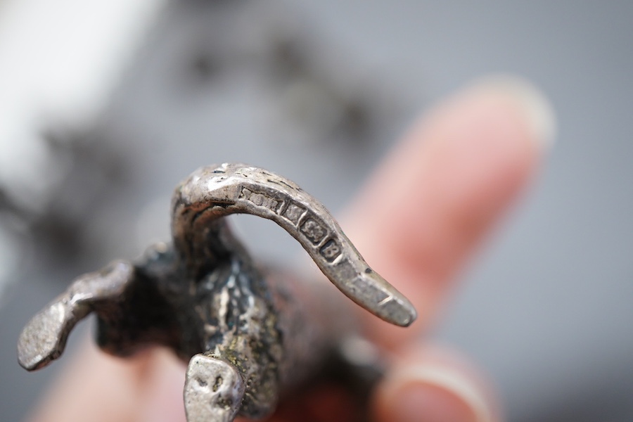An Elizabeth II silver four piece miniature cat band by S.J. Rose & Son, Birmingham, 1976, tallest 58mm, together with a modern 925 miniature model of a standing grizzly bear and a modern silver model of a kitten(filled)